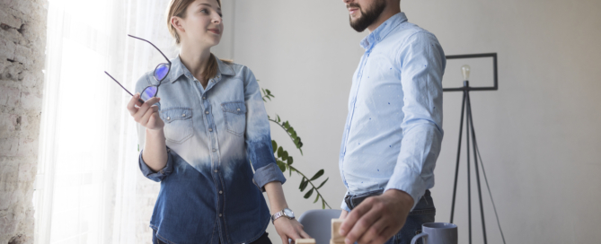 Young colleagues looking each other office