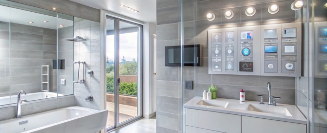 Modern bathroom with a bathtub, double sink vanity and smart home technology.