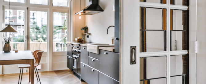 Interior shot of a modern kitchen with decorations and furniture next to an entrance