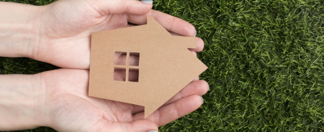 Hands with miniature house